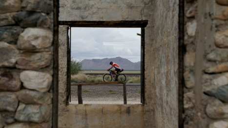 The Elephant In The States: Cycling Through America During Tense Times On The North American Epic Keith-Elliott-rides-past-abandoned-buildings-outside-of-Salome,-Arizona