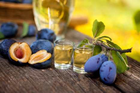 Plums and shot glasses on the table