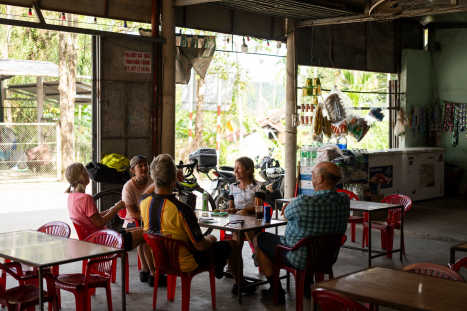 A-group-of-riders-take-a-coke-stop-break-on-a-sunny-day-in-Vietnam.