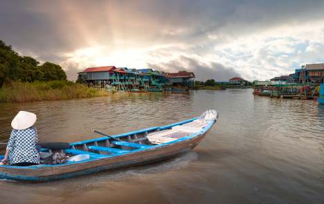 The Bamboo Road: Cambodia Update Tonle Sap lake, Siem reap Province, Cambodia. Fisherman in his boat, Floating village of Kompong Phluk, Cambodia.