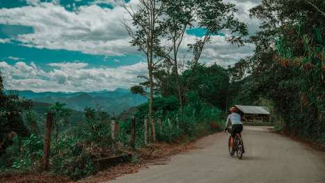 Mike-Cote-rides-through-a-scenic-backroad-towards-La-Vega