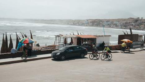 Joanne-Snow-and-Jonna-Koch-cycle-into-the-surf-town-of-Huanchaco