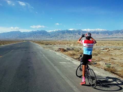 Ben enjoying the view with mountains one side, sand dunes the other