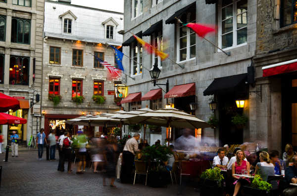 "Montreal, Canada - August 23, 2012: People dine on the patio of a restaurant along Rue Saint Vincent, while others mill around nearby, in the Old Montreal section of Montreal."