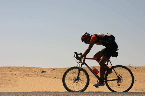 Sam sailing through the Sahara on blissful blacktop