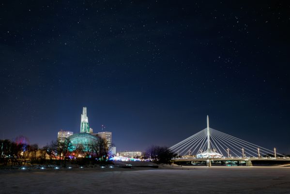 City of Winnipeg skyline at night in winter.  Esplanade RIel and the Canadian Museum for Human Rights in view.