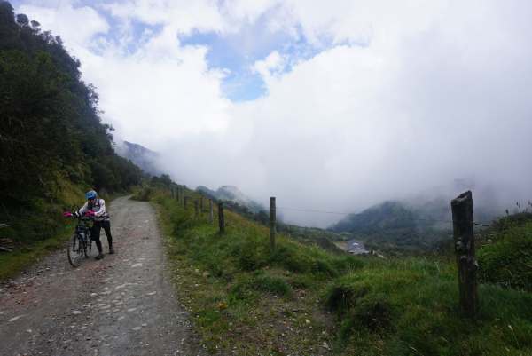 It doesn't matter how you go up, but just keep going. A derailleur change forced Tim to walk many kilometers up and out of the clouds.