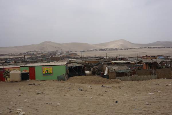 small desolate town at the base of the sand dunes