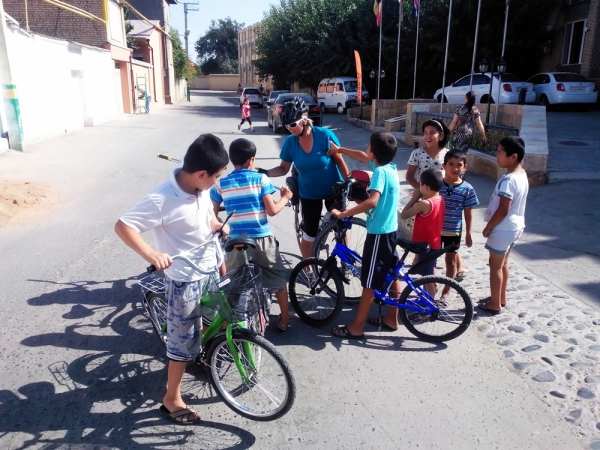 sylvie and local biker kids in samarkand