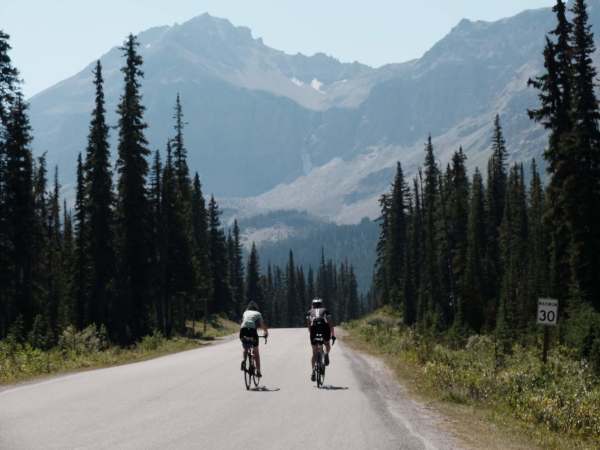 Marielle and Beate dwarfed by trees and mountains.