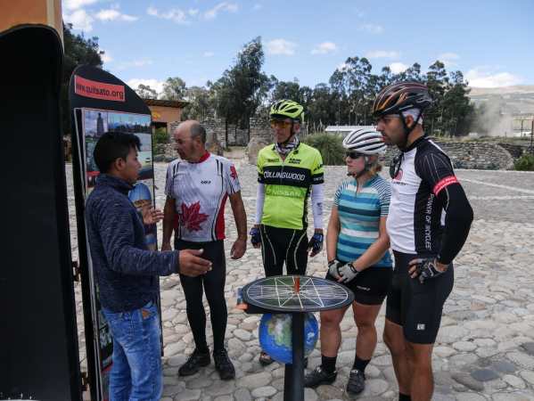 Blog - Lloyd, Tom, Becky, and Bruce, listen to a local guide at the equator monument