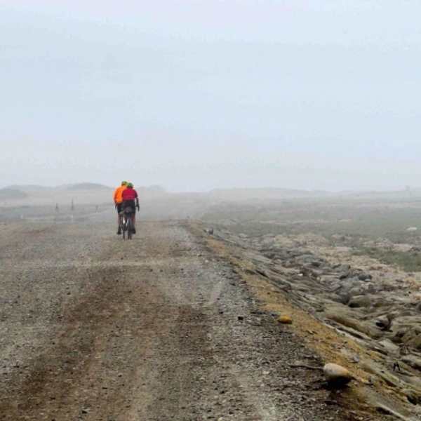 Mark and Nelson ride off into the fog of the coast