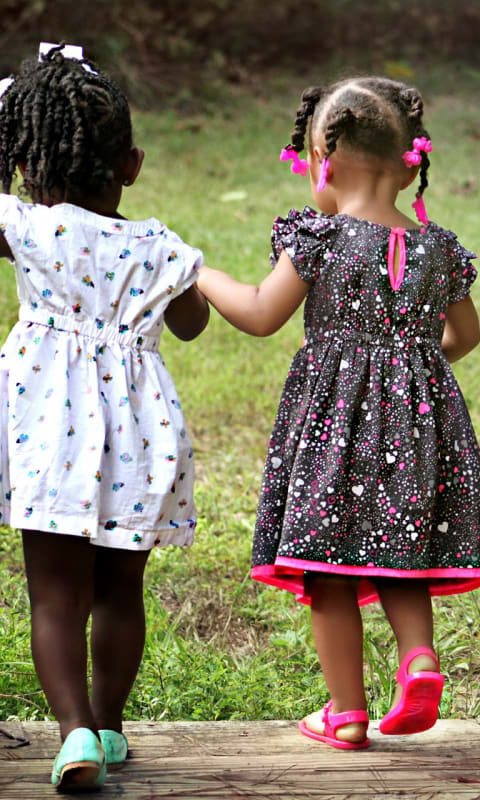 small image of girls holding hands