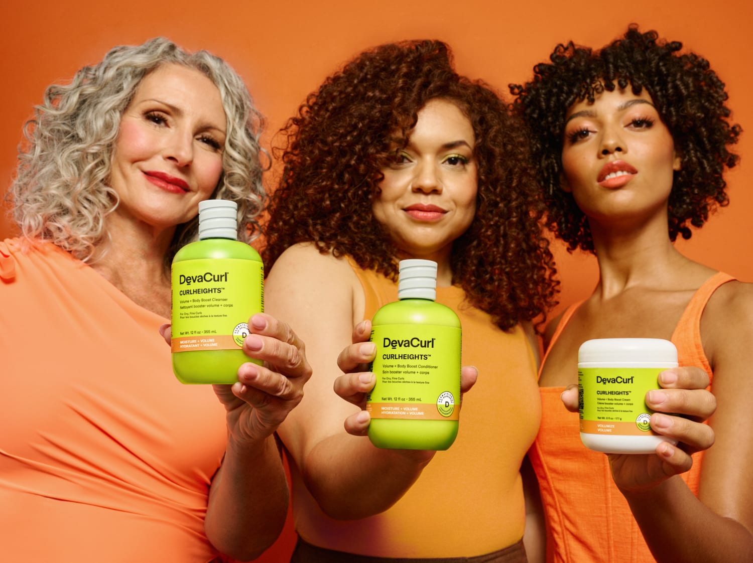 Models holding curlheights cleanser, conditioner + cream bottles