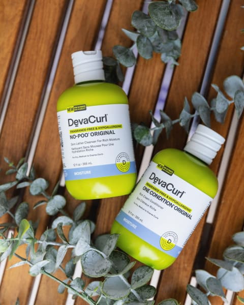 DevaCurl Fragrance Free Hypoallergenic Original Cleanser, Conditioner bottles with eucalyptus as decor