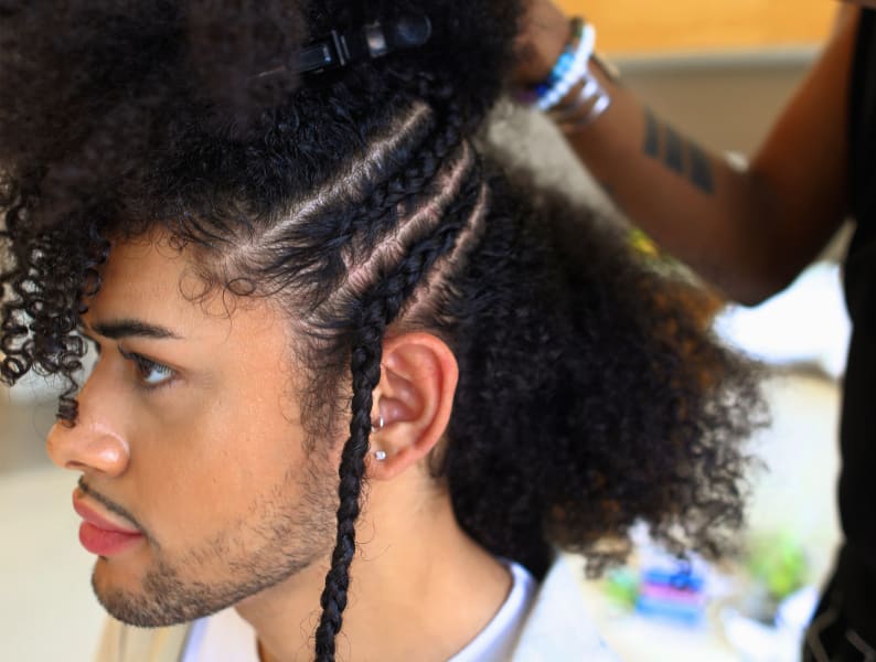 Man getting hair braided - DevaCurl Pro FlexFactor curly hair primer