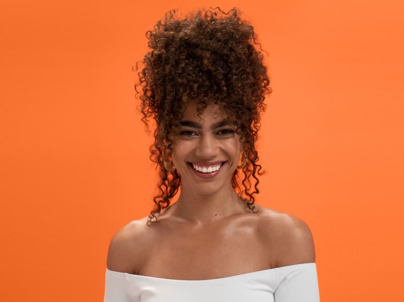 Woman with curly hair laughing