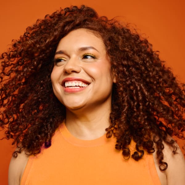 Smiling woman with brown curly hair