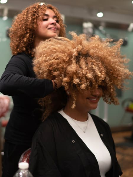 stylist with hands in hair