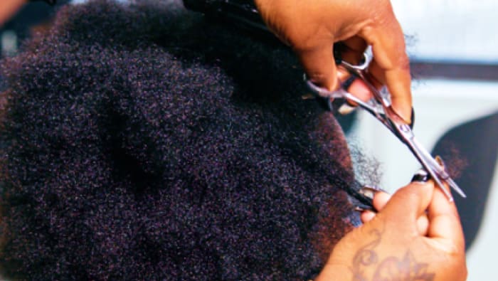 Stylist hands cutting wavy hair