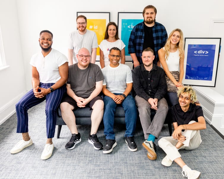 The team at Develo sitting on a sofa in the office