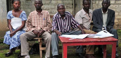 Why do the women remain invisible, in spite of their presence?