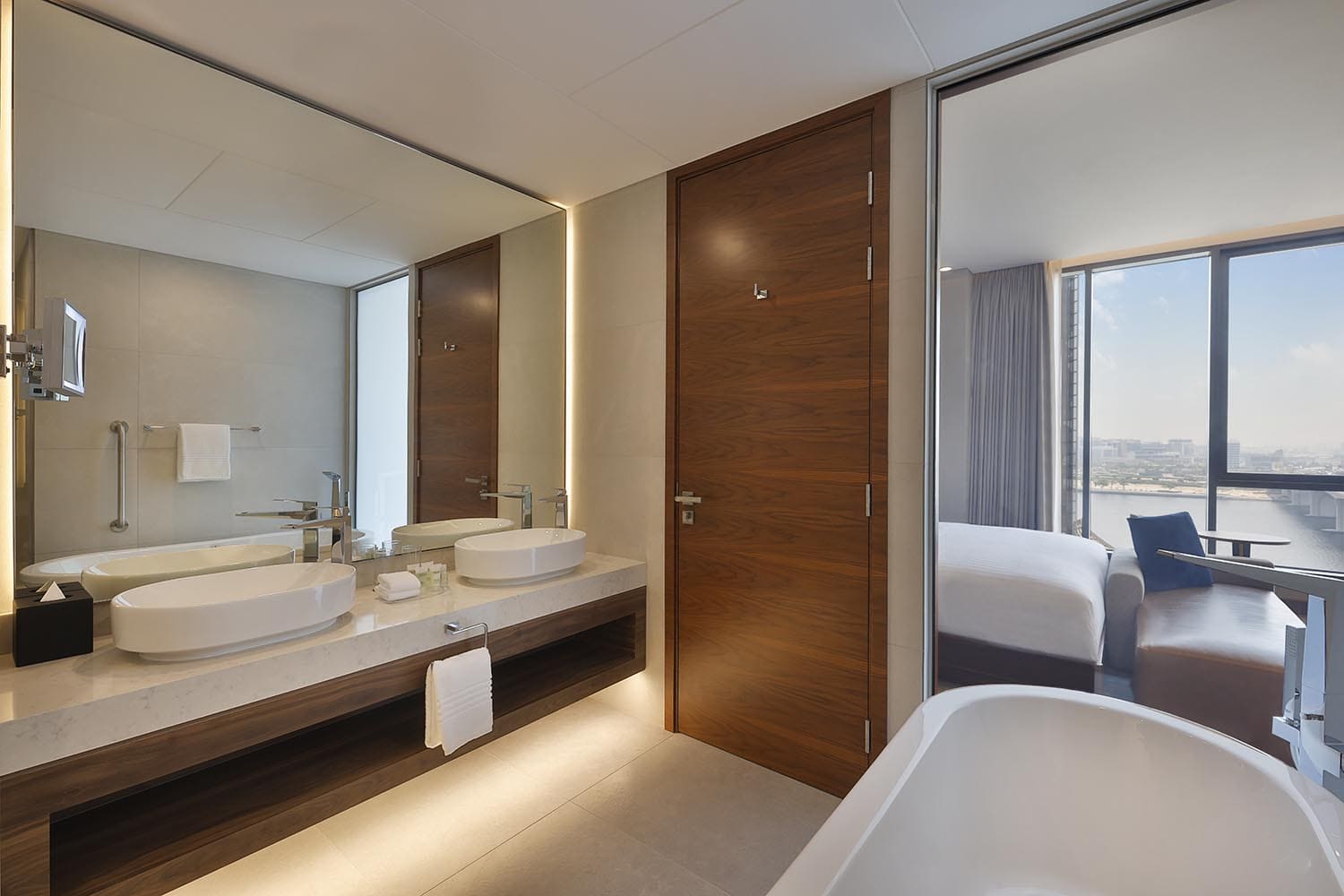 Suite bathroom with two sinks window open