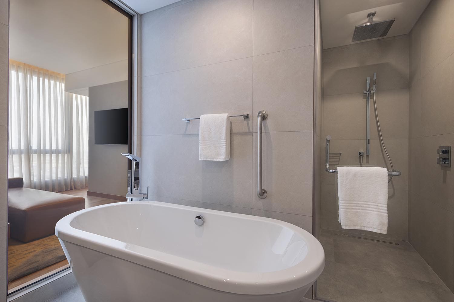 Suite bathroom with tub and shower window open