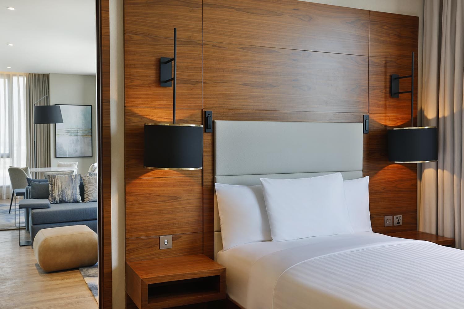 Single bed guestroom with living room behind