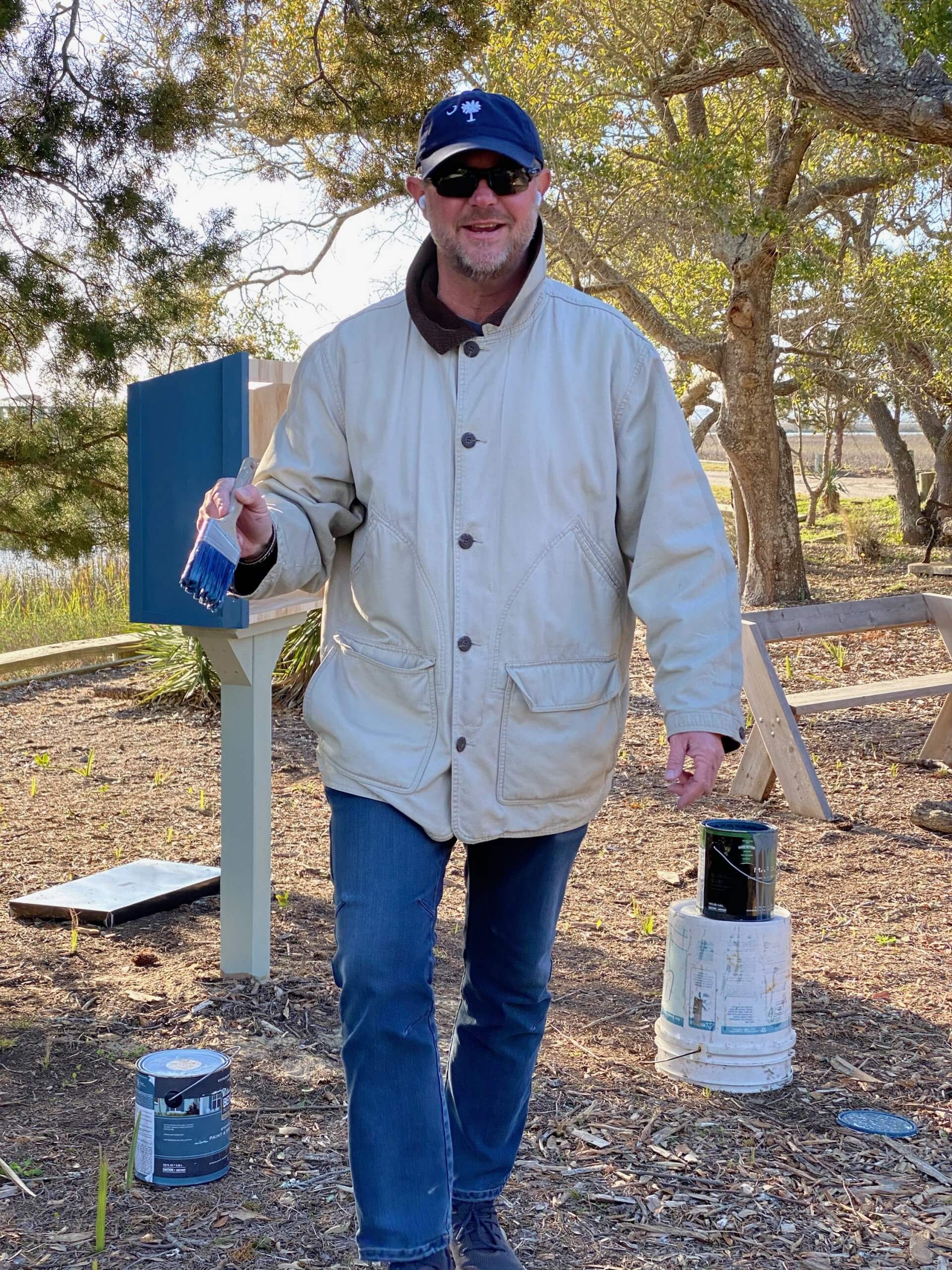 Chris paints the little free library