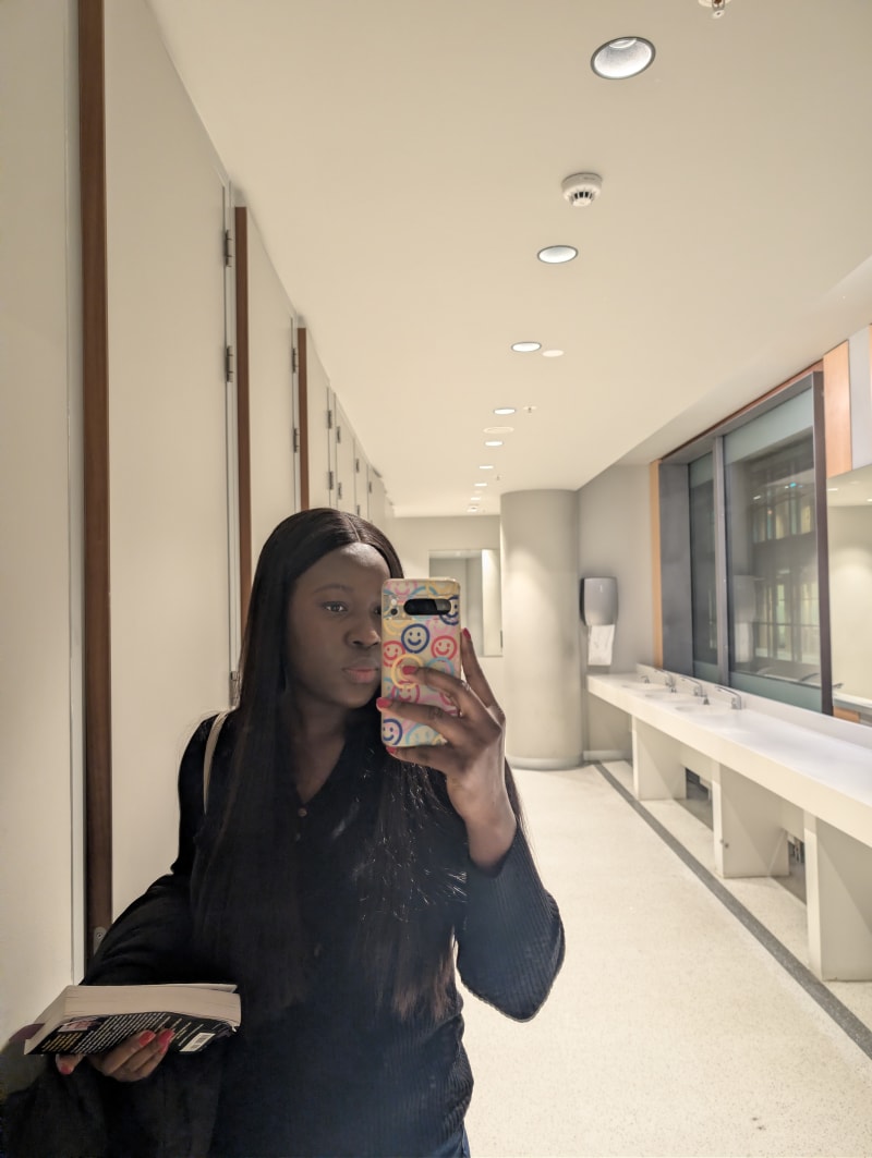 Olufunke Moronfolu taking a closed-up mirror selfie at WTD meetup in November. Location is OBA Oosterdok café, Amsterdam, Netherlands.