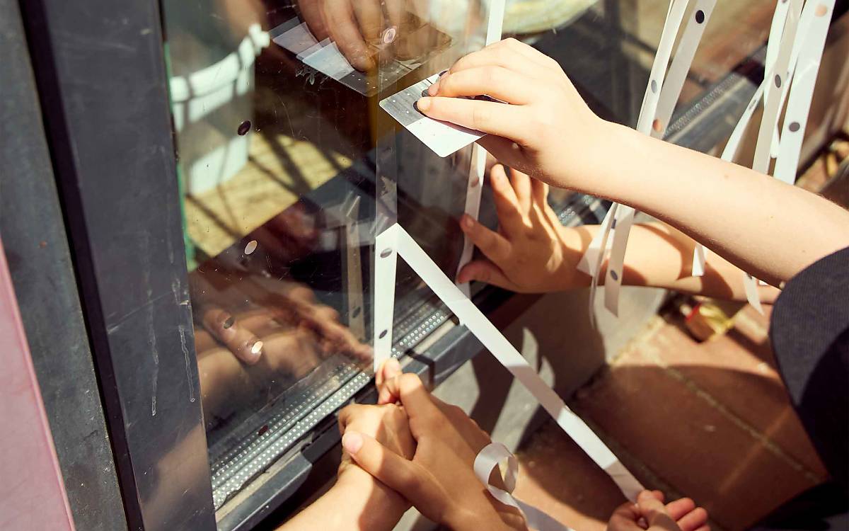 So geht’s auch: Die Kinder bekleben eine Scheibe mit einem Muster, das für Vögel erkennbar ist.