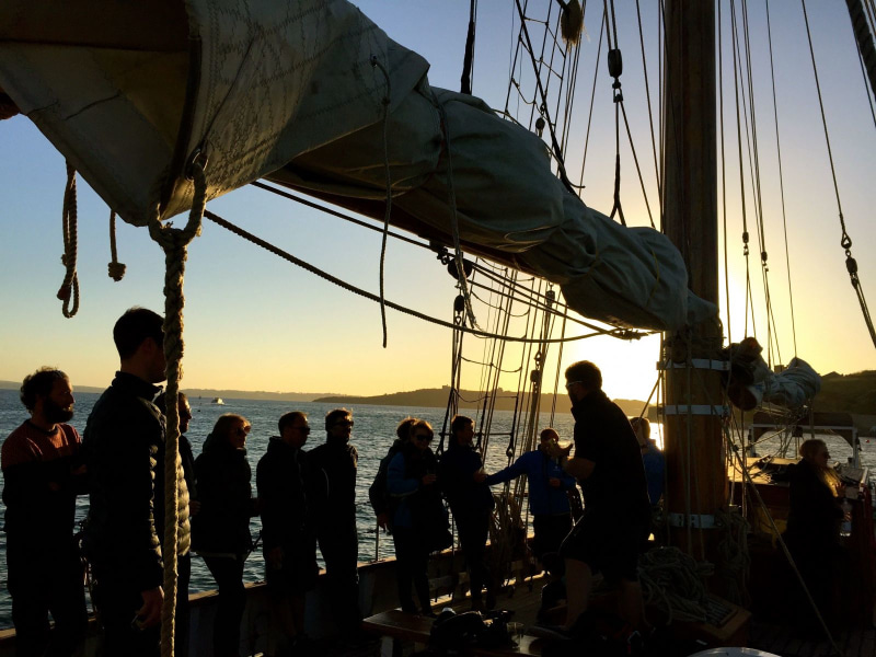 team deck sailing sunset