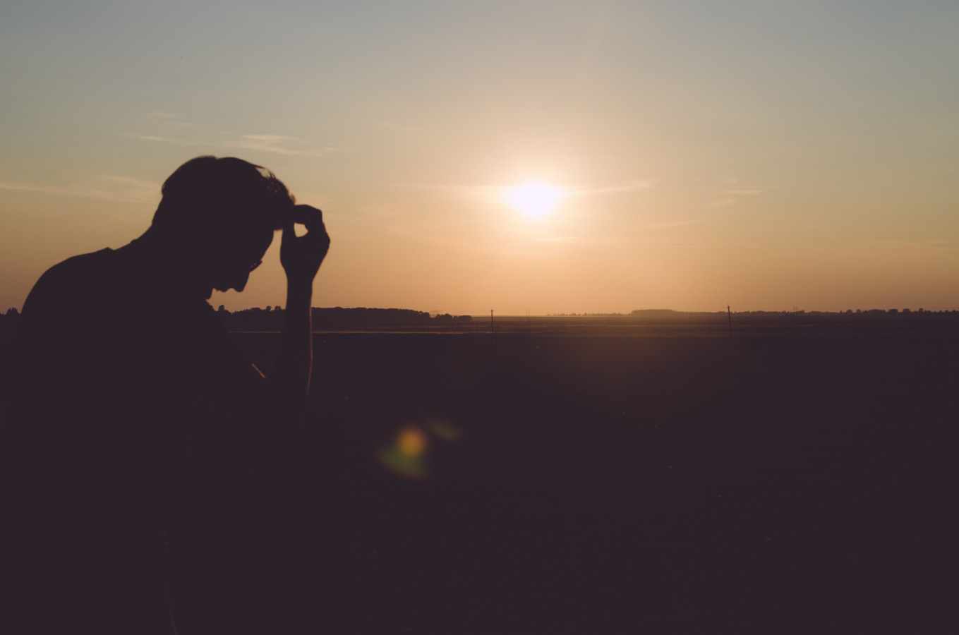 Silhouette of man outside at sunset