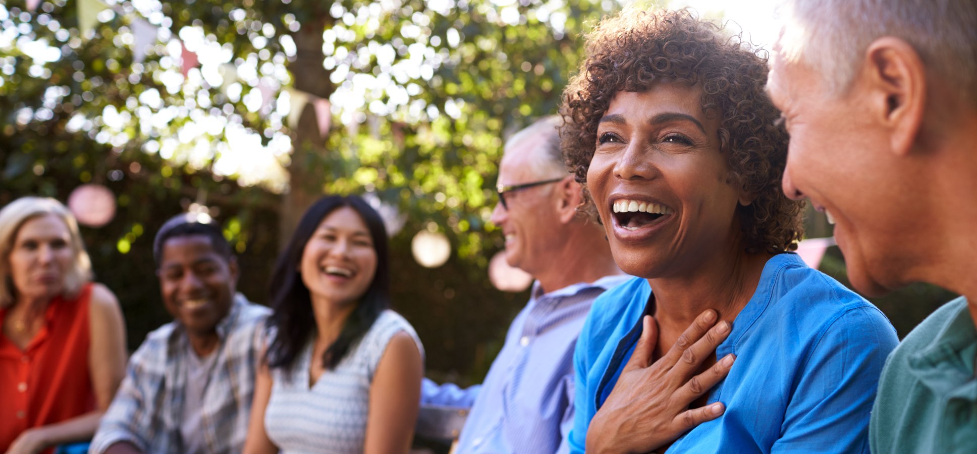 The Hearing Care Partnership lifestyle image of a woman having fun at a family barbeque