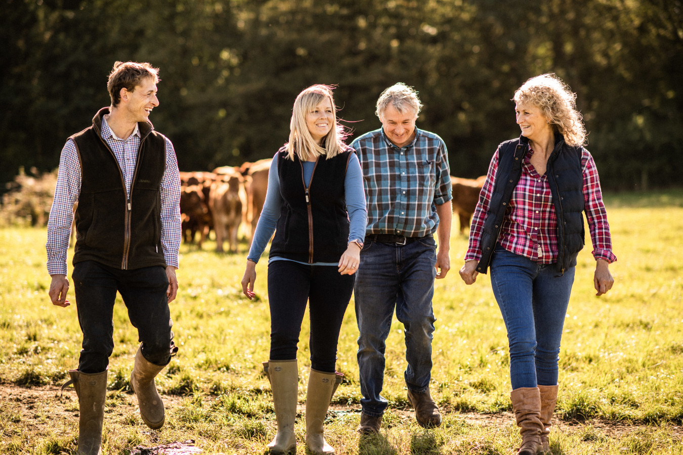 Mounce Family walking and laughing together through field on their farm