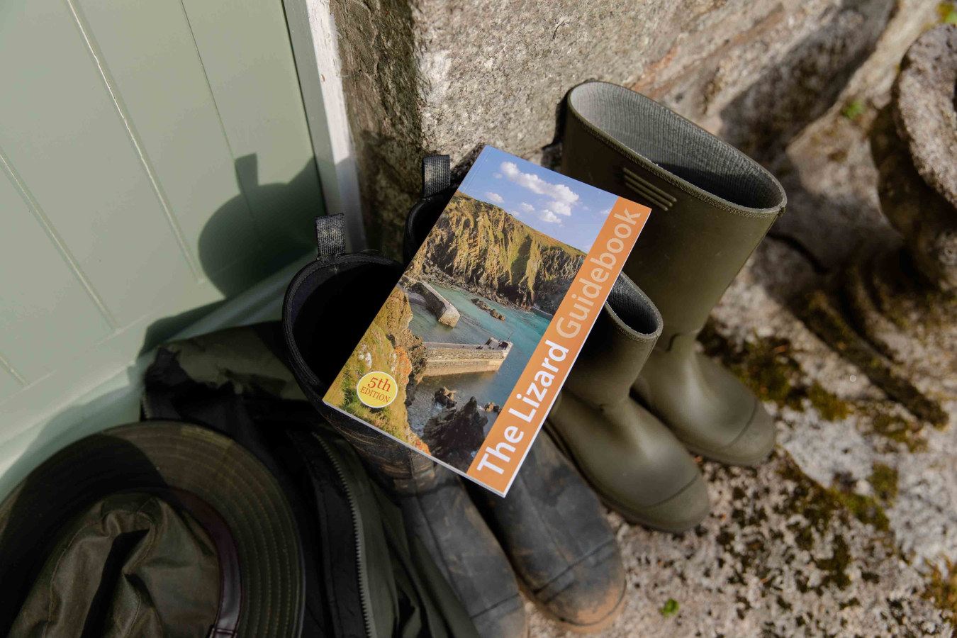 Friendly Guide Book resting on Wellngton Boots outside