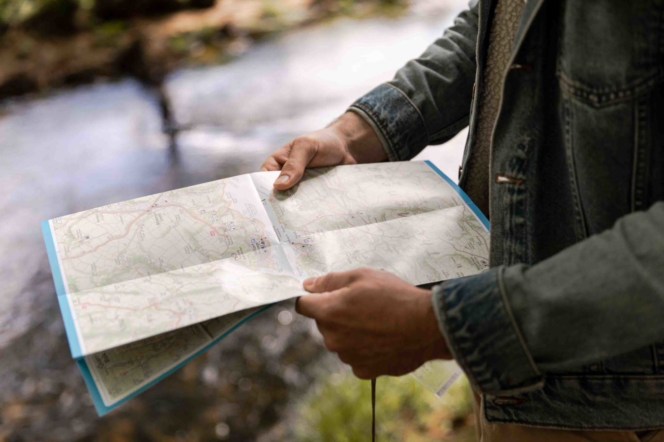 Man holding map by river