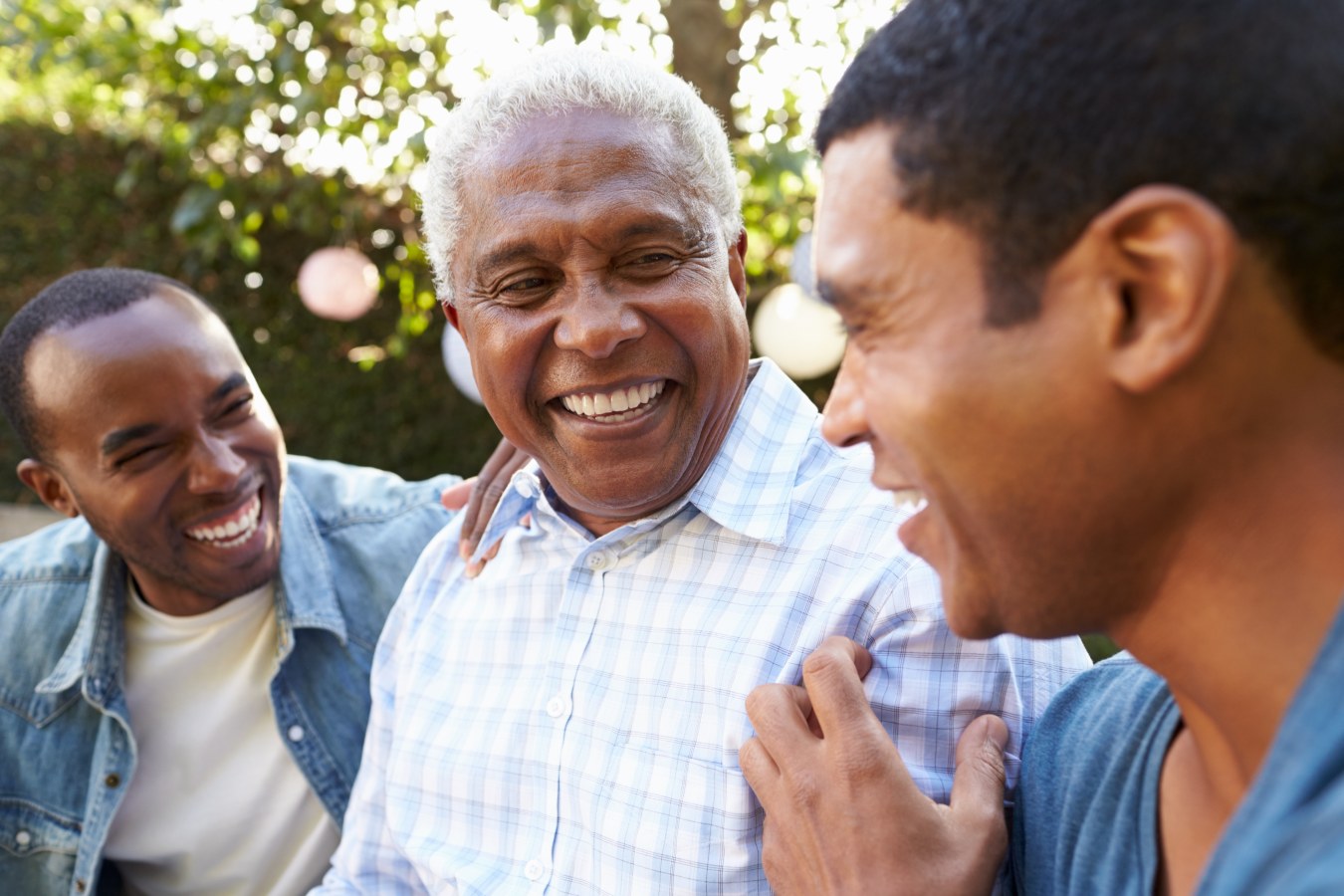 The Hearing Care Partnership photograph of a family laughing in the garden