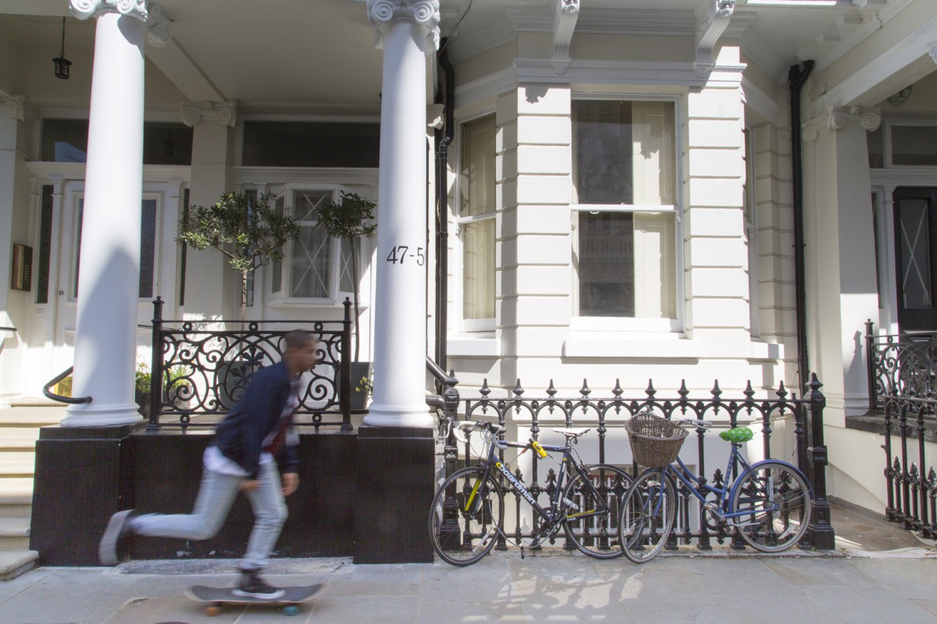 Richmond University image of a man skateboarding outside a block of flats in London