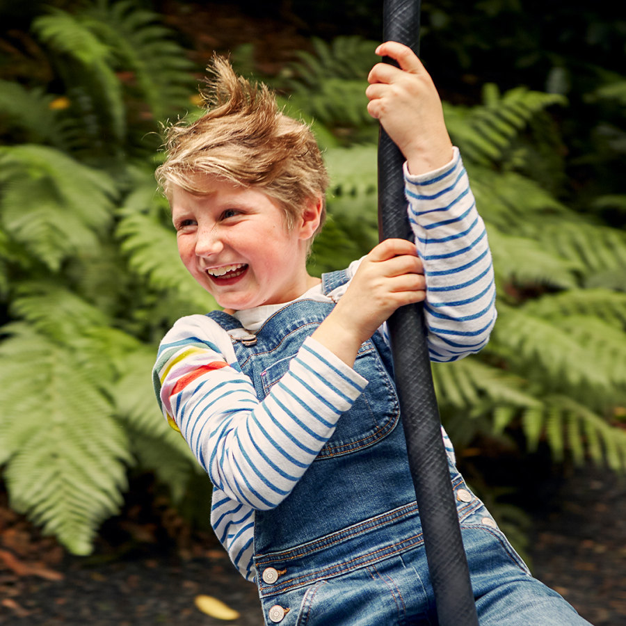 Child on a zip wire at Trebah Gardens Cornwall at square ratio