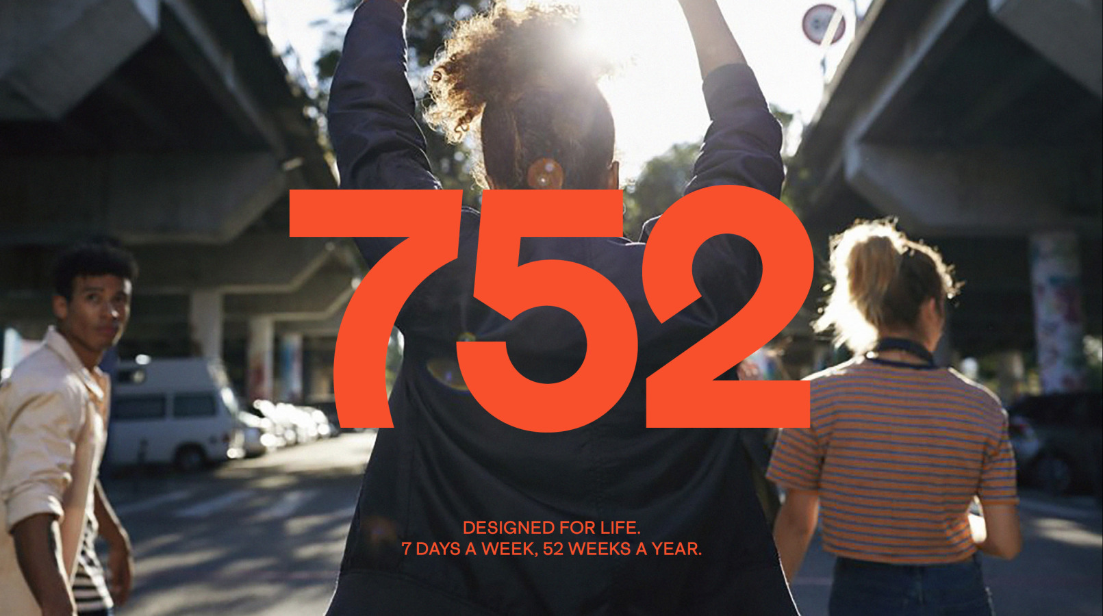 752 logo over layed on image of woman walking away with her hands in the air