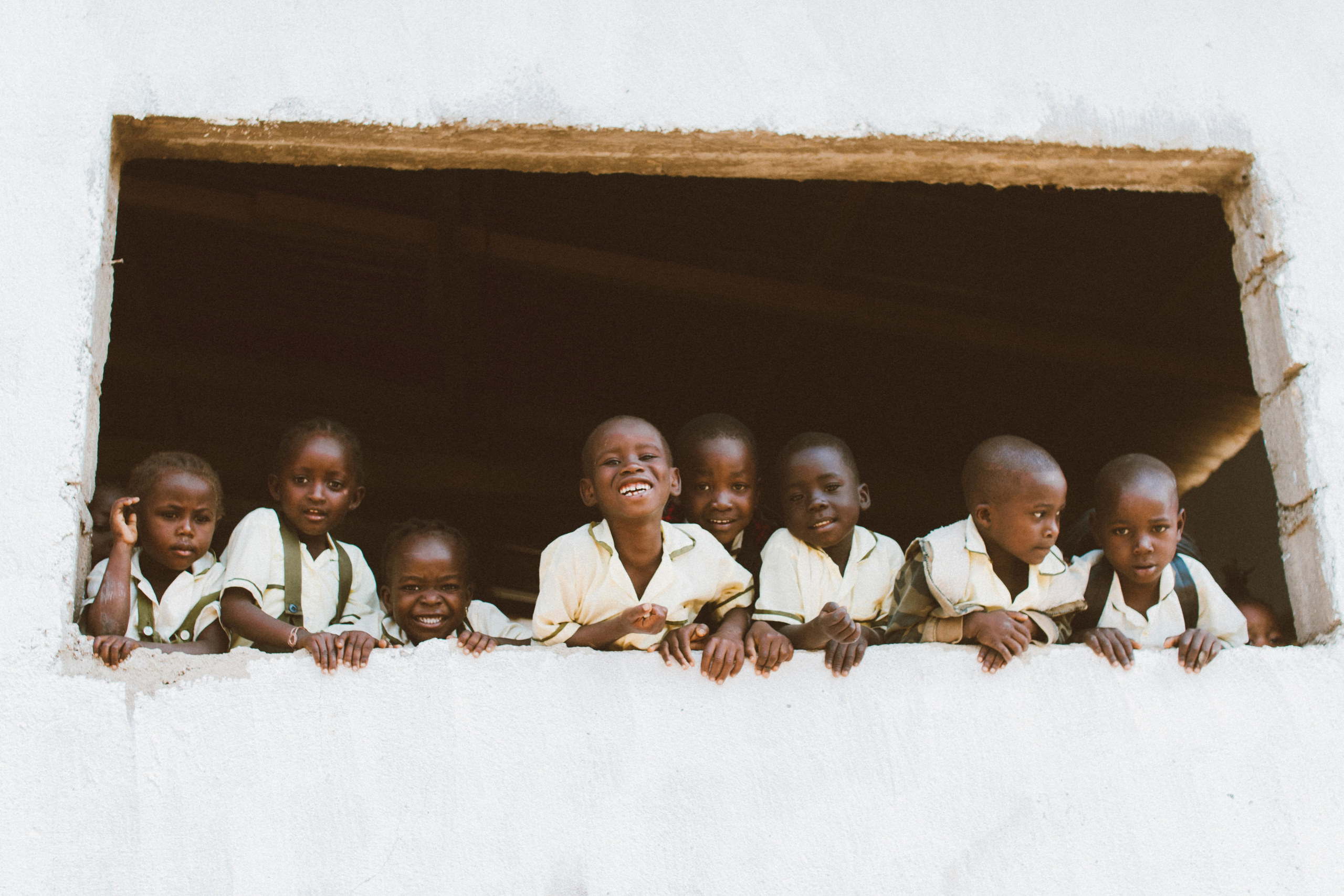 Group of children looking out of the window