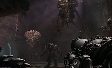 Two Cacodemons loom menacingly above the Slayer as a third demons lurks in the shadows behind them.