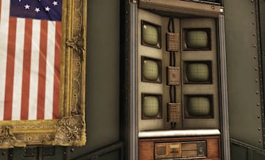 Fallout 76 screenshot showing the Battle-Scarred Bundle. On the left is a framed American flag with thirteen stars in a circle. In the center is a vintage control panel with six CRT monitors and various buttons. On the right is a DEFCON board with color-coded levels from 5 (blue) to 1 (red), all set against an industrial metal wall.
