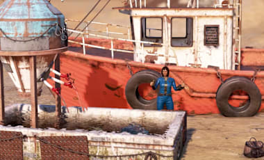 Character in blue jumpsuit stands by a red fishing boat and fish tank on a sandy shore.