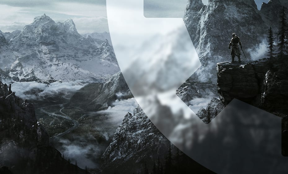 The Dragonborn stands on a cliff overlooking a vast, snowy mountainous landscape. A winding river snakes through the valley below, and grey clouds hover above. A faint Bethesda Game Studio Gear Logo is subtly integrated into the foreground.