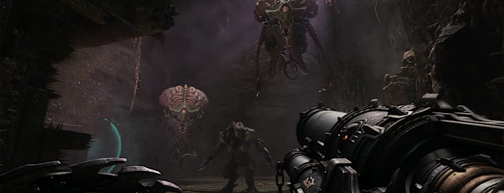 Two Cacodemons loom menacingly above the Slayer as a third demons lurks in the shadows behind them.