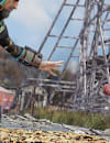 Two characters, a human and a ghoul, facing one another prepared to fight. They stand in front of a wooden rollercoaster in a rundown amusement park. 