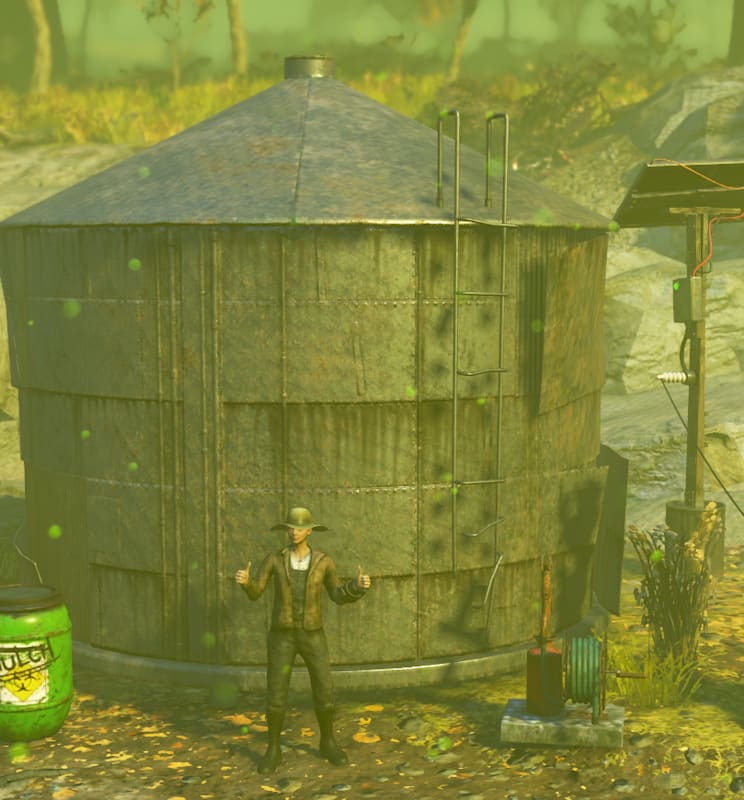 An image from Fallout 76 featuring a Weather Control Station (Blooming Haze) emitting green haze, a Poisoned Earth Well with toxic barrels nearby, a large Steel Silo in the center, and a Mulch Barrel on the right. The background shows a rocky terrain with sparse vegetation under an overcast sky